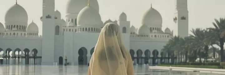 Veiled girl walks towards the mosque