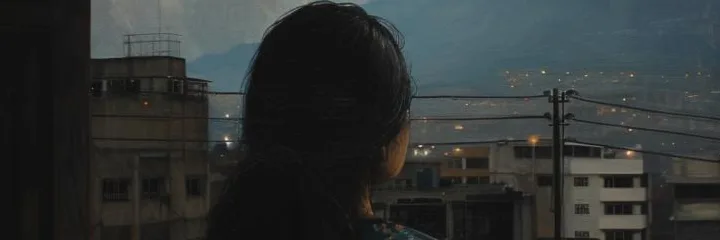 Girl at the window in the dark