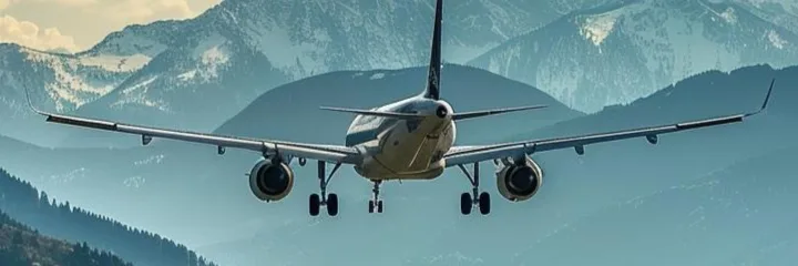 An airplane at the foot of the mountains